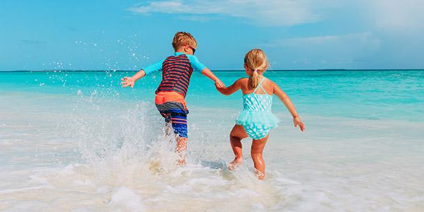 Kids running into the ocean
