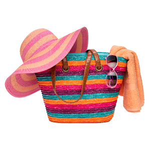 colorful beach bag filled with a wide brimmed hat, sunglasses and towel