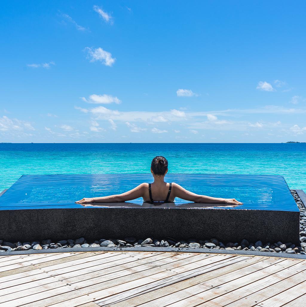 Woman relaxing in a pool in the Indian Ocean