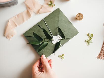 Wedding invitation in green envelope with a wax seal