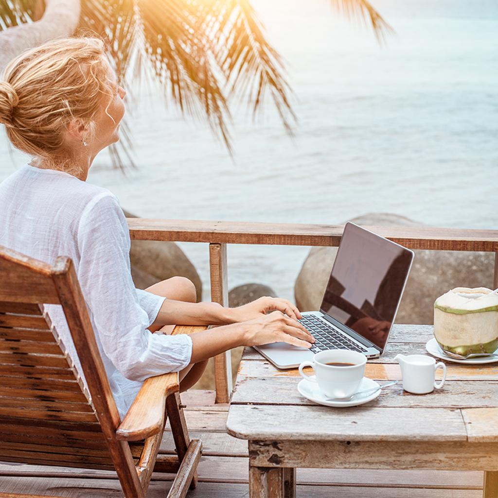 A woman works remotely from a deck