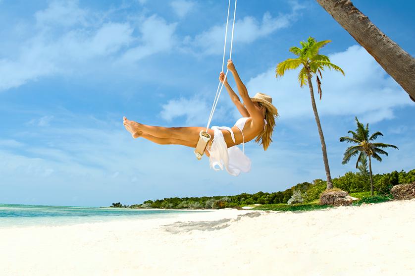 woman on a swing on the beach